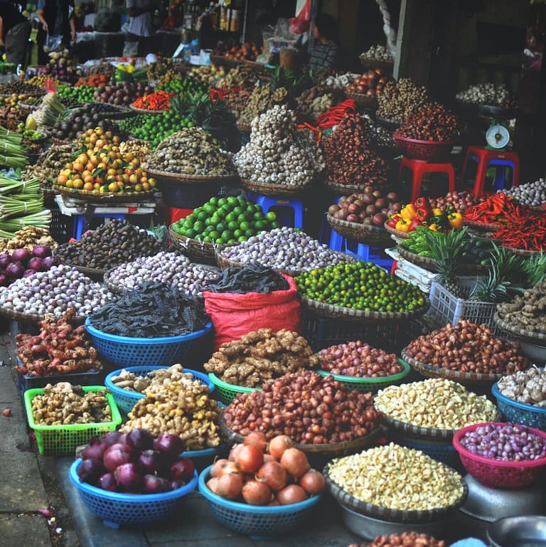Piles of produce, grains and other product being sold at street market